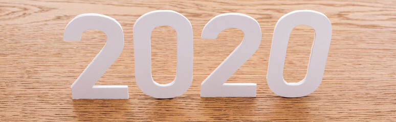 paper white 2020 numbers on wooden brown background, panoramic shot