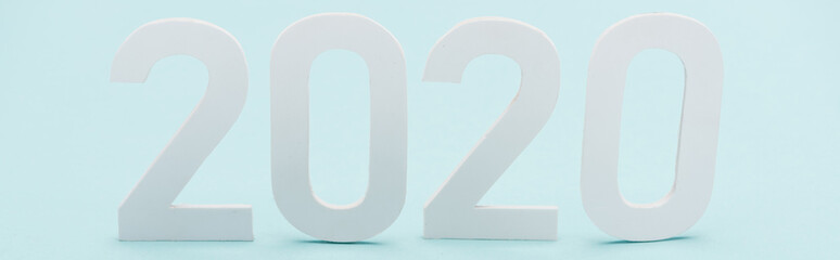 panoramic shot of white 2020 numbers on light blue background