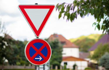 Two traffic sign on top of each other. A triangular sign means to pay attention to the right of...