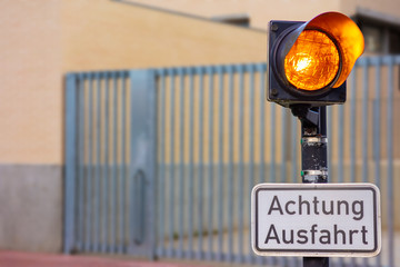 At an electric gate of an exit from a company premises is a sign. The exit must not be blocked....