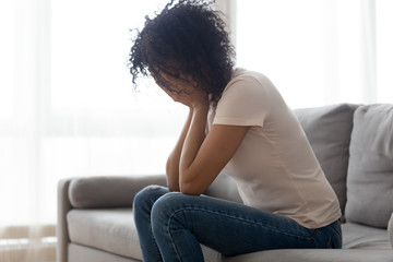 Stressed black woman crying having personal problems