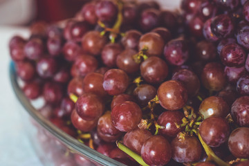 A bowl of red grapes on the table