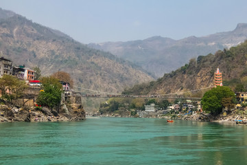 Naklejka premium Rishikesh, India. View of Ganga river embankment and Tera Manzil Temple, Trimbakeshwar in Rishikesh.