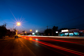 Fototapeta na wymiar Top veiw Car lights, night road,light trails on motorway highway at night, long exposure abstract urban background,Sisaket province,Thailand.