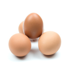 Four brown eggs separated from the white background.