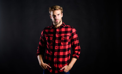 Naklejka premium Barbershop and beauty salon. Hipster black background. Standards of manliness or masculinity. Handsome well groomed man in checkered shirt. Manliness concept. Meaning of modern manliness. Male beauty
