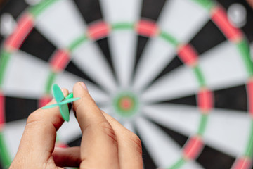dart on hand before trowing to get win on dartboard target business and idea concept
