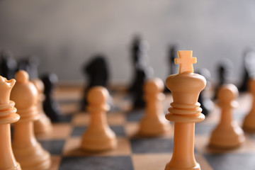 Chess board with chess, black and white on a gray background