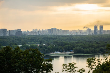 Naklejka premium Tour of Kiev in the center of Europe. View of the Dnieper, Trukhanov island and a foot bridge. Park fountain and sunset on the horizon..