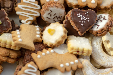 Many kinds of Christmas cookies in one pile in the box, various colors and tastes