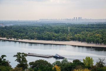 Obraz premium Tour of Kiev in the center of Europe. View of the Dnieper, Trukhanov island and a foot bridge. Park fountain and sunset on the horizon..