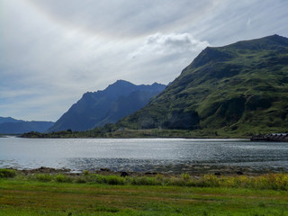 picture with mountain silhouettes and solar glares of light on the water surface