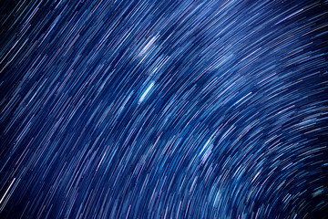 Star trails movement at night.Abstract long exposure of strail trails against a blue sky at dark...