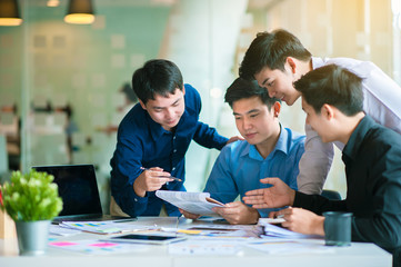 A group of busy business men working on a plan.