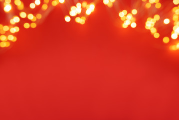 Border of defocused Christmas lights on red background. Christmas and New Year holidays celebration...