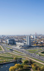 City architectural landscape Minsk. Office buildings of the road and parks. View from the roof with blue sky.