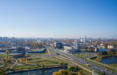 City architectural landscape Minsk. Office buildings of the road and parks. View from the roof with blue sky.
