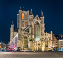 Fototapeta premium The Saint Nicholas Church facade in Ghent at night. One of the most important buildings and landmarks in Romanesque and Scheldt Gothic style in the historic center of Gent, Belgium.