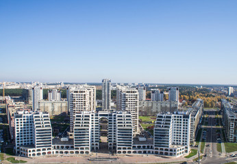 City architectural landscape Minsk. Office buildings of the road and parks. View from the roof with blue sky.