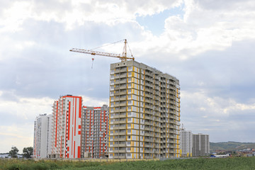Fototapeta na wymiar high-rise building construction. Construction crane against the sky. City under construction