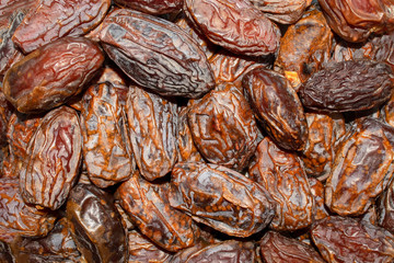 Dates background. Fresh arabic dates. Date palm fruit. Top view. Dried date fruit texture.