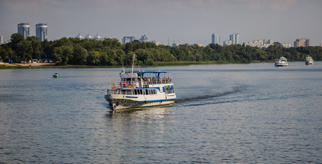 Obraz premium Tour of Kiev in the center of Europe. View of the Dnieper, Trukhanov island and a foot bridge. Park fountain and sunset on the horizon..