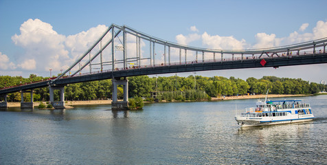 Tour of Kiev in the center of Europe. View of the Dnieper, Trukhanov island and a foot bridge. Park fountain and sunset on the horizon..