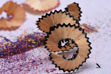 wooden shavings from colored pencils on a white background close-up