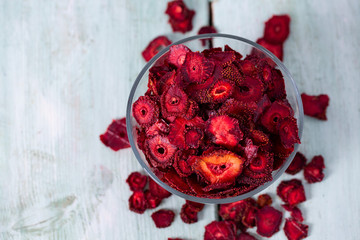 dried sliced strawberry on a wooden surface