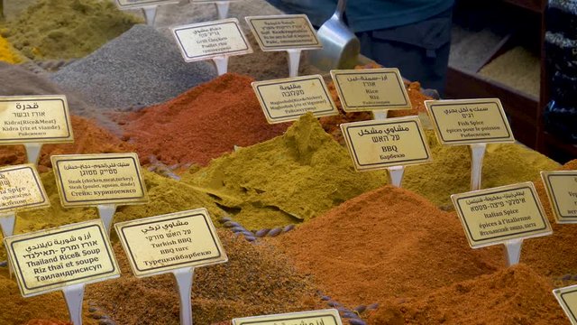Mounds of exotic spices are scooped up and bagged for purchase in this oriental spice shop