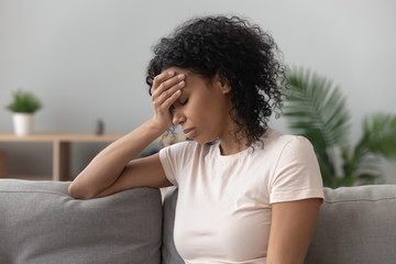 Depressed black woman feel upset mourning at home