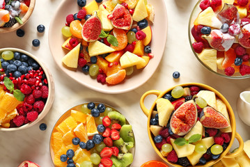 Different tasty salad with fruits on white background