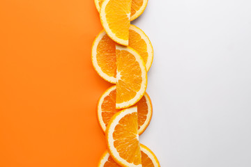 Slices of fresh orange fruit on color background