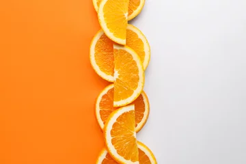 Poster Slices of fresh orange fruit on color background © Pixel-Shot