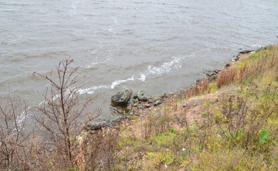 The shore of the lake on a gloomy autumn day