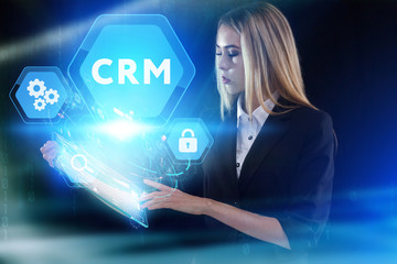 Business, Technology, Internet and network concept. Young businessman working on a virtual screen of the future and sees the inscription: CRM