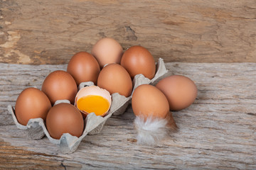 The chicken eggs in the panel are placed on a brown wooden background.
