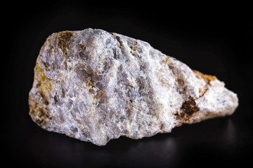 Rock, isolated on black background, stones or gravel used for construction of buildings, roads and for landscaping (close up).
