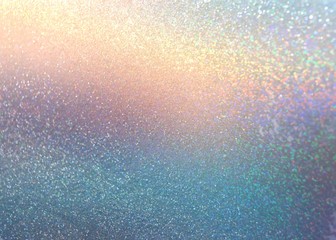 Shimmer on yellow pink blue gradient cool background. Glitter pattern. Sparkles texture.