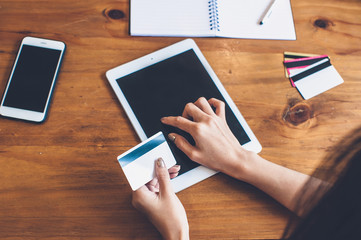 Women are shopping online with a tablet using a credit card.