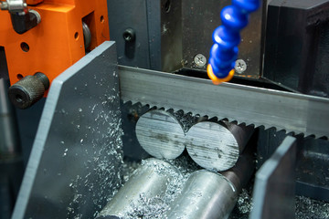 The operation of band saw machine cutting the metal rod. The ingot material preparation for...