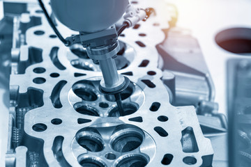 The aluminium casting cylinder head parts in the assembly process with the exhaust and intake valve...