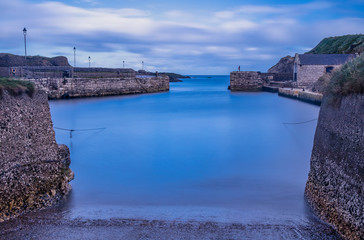 Fototapeta premium Long exposure of Ballintoy harbour, Game of Thrones filming location for iron islands harbour, Causeway coastal route, County Antrim, Northern Ireland
