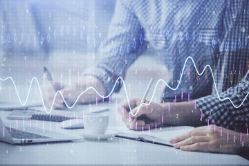 Multi exposure of forex chart with man working on computer on background. Concept of market...