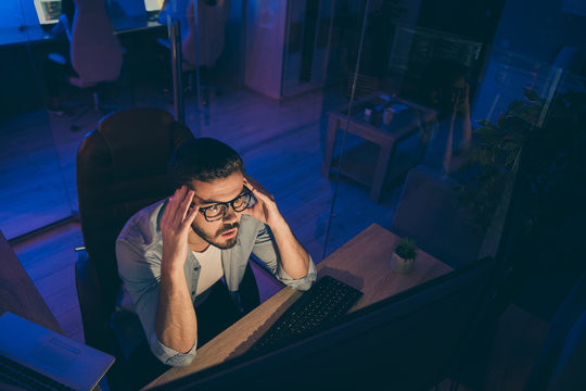 Hign angle above view photo of it skilled specialist guy sitting chair looking many monitors not believe eyes analyzing server back-end security bad code night office indoors