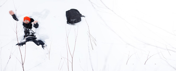 A man in the winter in the forest. A tourist with a backpack goes through the woods in winter. Winter ascent.