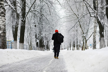 Winter walk with an umbrella.Man in a coat with an umbrella, walk against the backdrop of the winter landscape, winter view