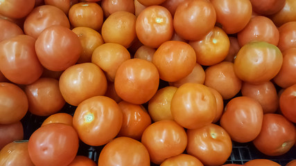 View of several red tomatoes on sale counter...