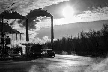 Power plant smokestacks emitting smoke over urban cityscape. Road retro style urban city. Ecology