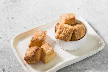 Cottage cheese cookies on a rectangular ceramic plate on a light gray background